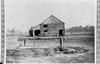 Dariy barn (note log construction) behind Price's boyhood home.